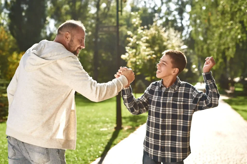 carer and a kid with downsyndrome in a park