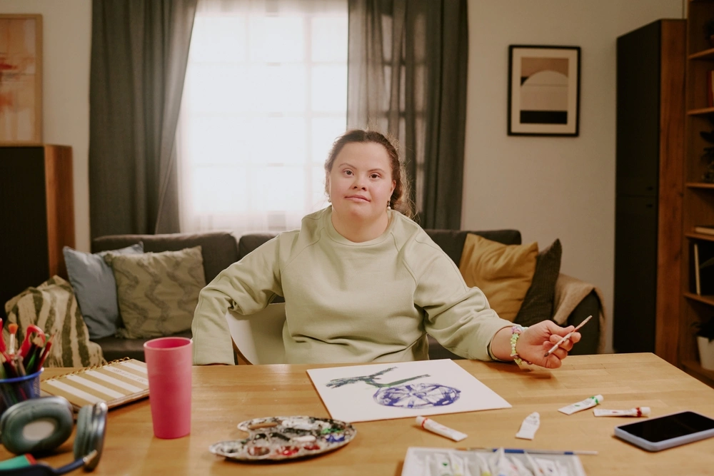 down syndrome disability women sketching in her home